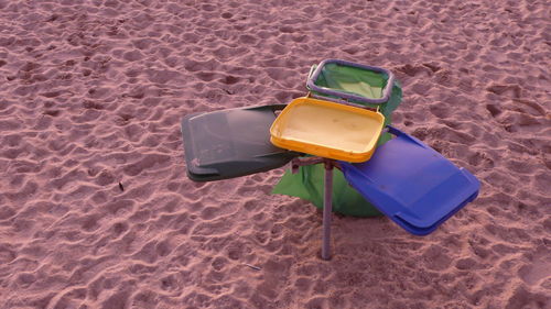 High angle view of sunglasses on sand