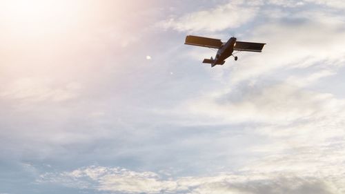 Low angle view of airplane flying in sky