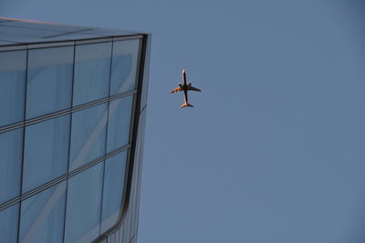 Low angle view of airplane flying in sky