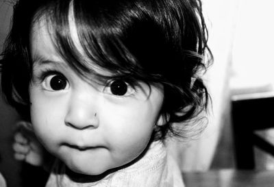 Close-up portrait of cute baby boy at home