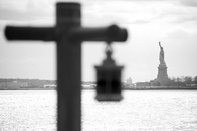 View of cross against cloudy sky