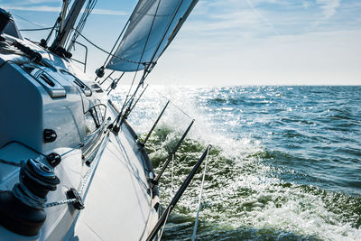 Sailboat sailing in sea against sky