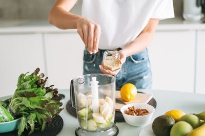 Midsection of man preparing food on table