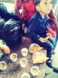 High angle view of people sitting on table