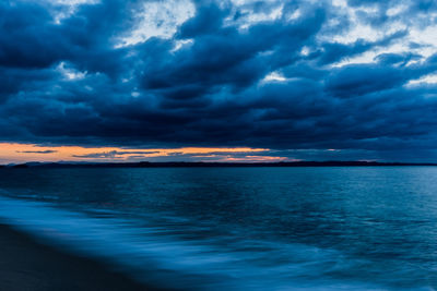 Scenic view of sea against dramatic sky