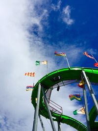 Low angle view of flags on rollercoaster track