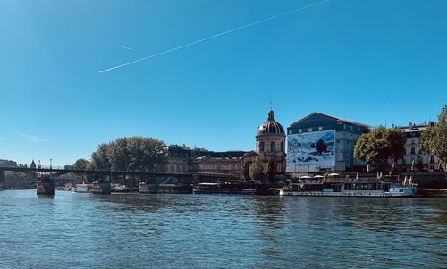 River by building against clear blue sky