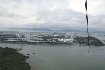 View of cityscape against cloudy sky