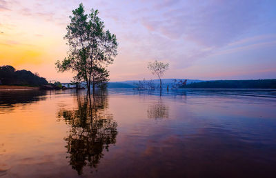 Scenic view of lake against sky at sunset