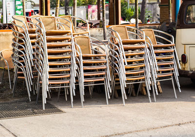 Empty chairs and tables at sidewalk cafe