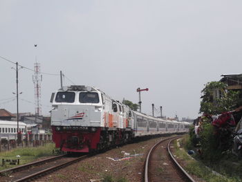 Train on railroad tracks against clear sky