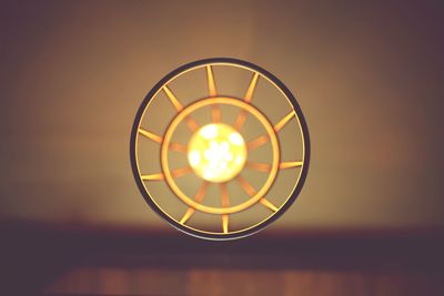 Directly below shot of illuminated pendant light hanging from ceiling 