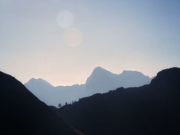 Scenic view of silhouette mountains against sky during sunset