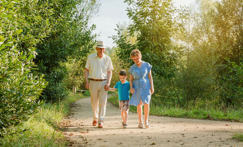 Grandparents and grandson walking in park 