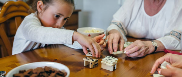 Close-up of hands holding people at table