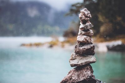 Close-up of stone stack on rock by sea