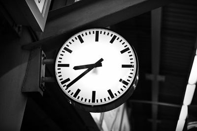 Low angle view of street clock at night