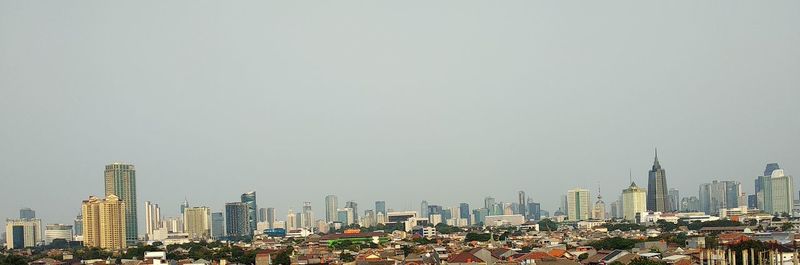 Aerial view of modern buildings against clear sky