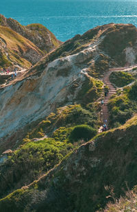 High angle view of land and sea against mountains