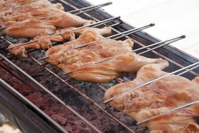 High angle view of meat on barbecue grill