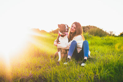 Woman with dog on field