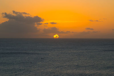 Scenic view of sea against orange sky