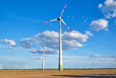 Windmill on field against sky