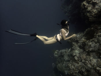 Freediving girl on reef