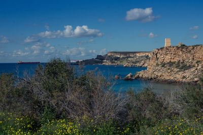 Scenic view of sea against blue sky