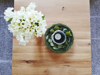 High angle view of white roses in vase on table