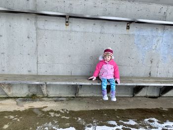 Full length of toddler standing against wall