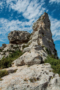 Cliff with blue cloudy sky, near baux-de-provence, france.