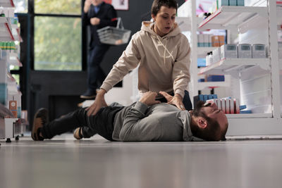 Side view of young woman exercising in gym