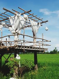 Traditional windmill on field against sky