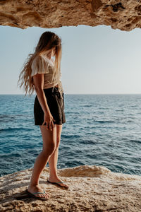 Young woman standing at beach