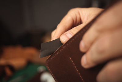 Sandpaper. tanner makes leather wallet, professional craftsman, business. handiwork.