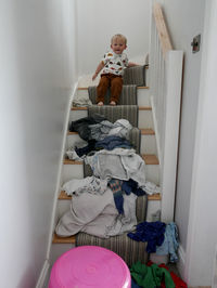 Boy sitting on stairs at home