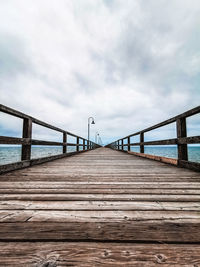 Pier over sea against sky