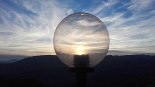 Close-up of light against sky during sunset