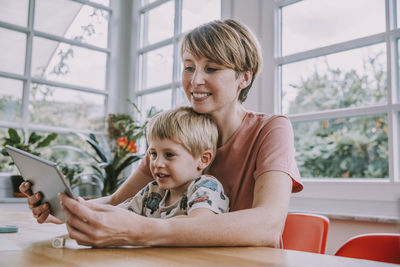 Portrait of smiling woman using mobile phone