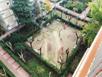 High angle view of bird amidst plants and buildings in city