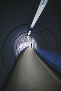 Man walking in tunnel