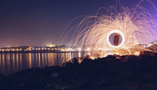 Firework display against clear sky at night