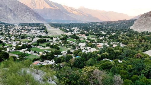 Scenic view of trees and buildings against mountains