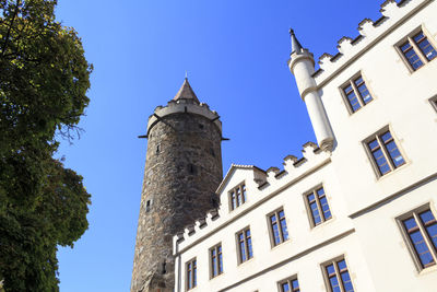 Low angle view of historic building against blue sky