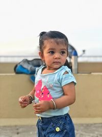 Cute boy standing on beach