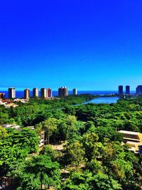 View of cityscape against clear blue sky