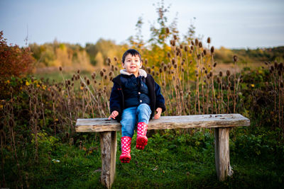 Small child sitting on bench