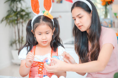 Portrait of cute girl holding women