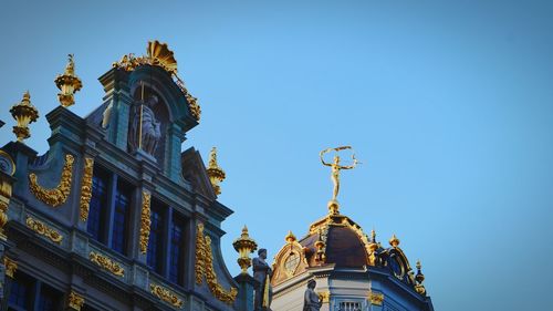 Low angle view of built structure against clear blue sky